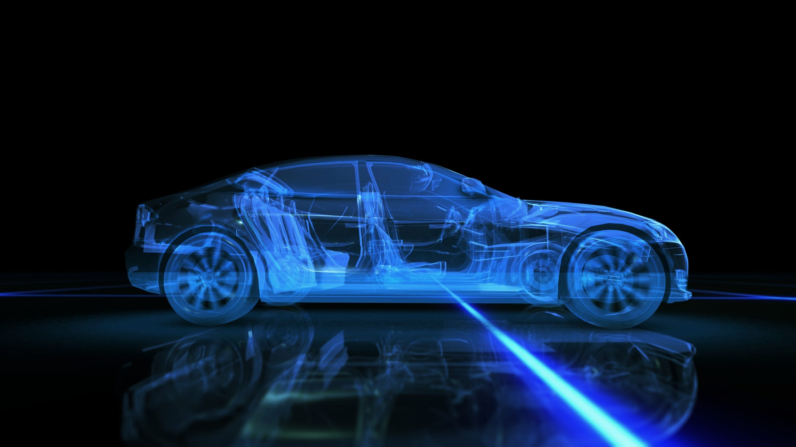  A blue, semi-transparent car with self-driving technology features drives on a black surface with a blue light trail.